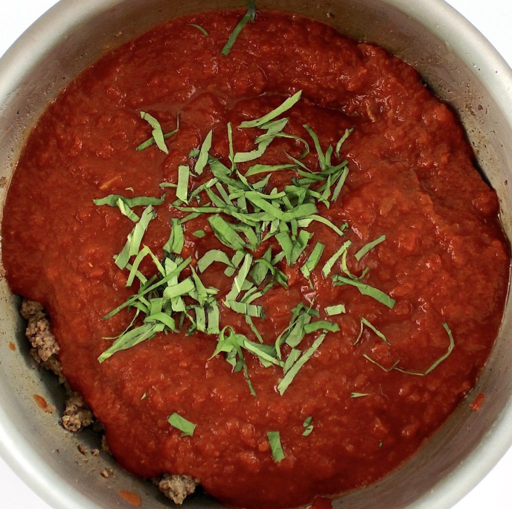 meat sauce with chopped fresh basil on top