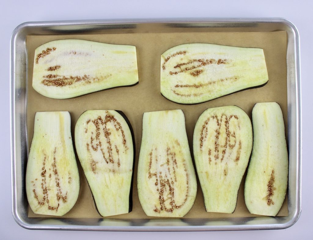 7 slices of eggplant on baking sheet lined with parchment paper