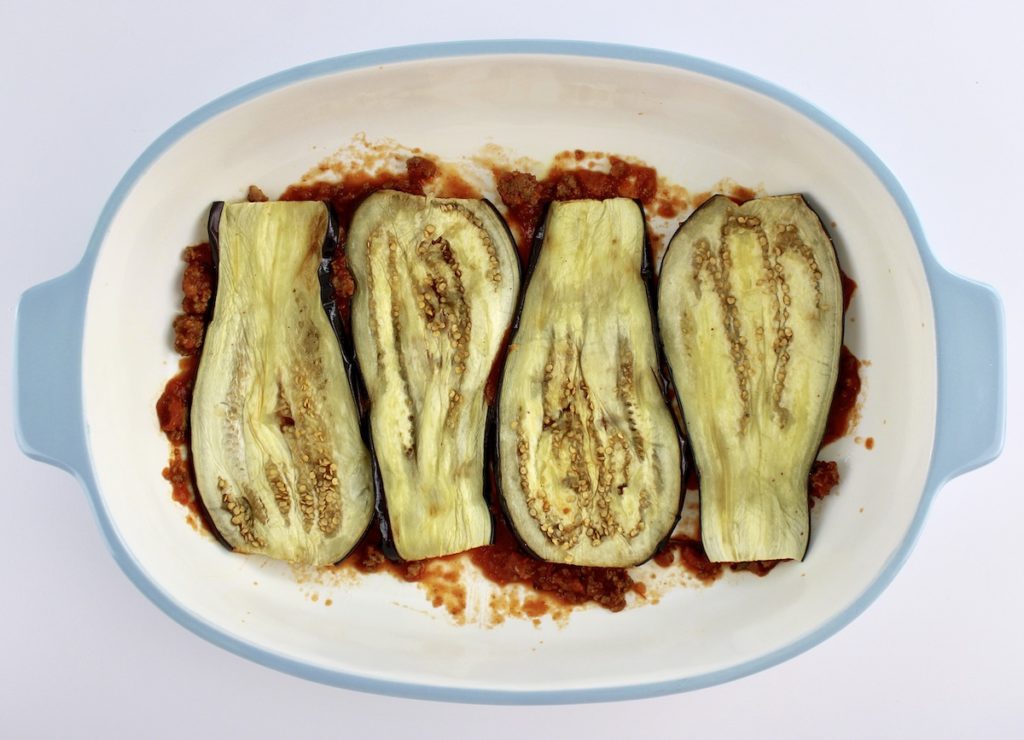 4 slices of eggplant in casserole with meat sauce underneath