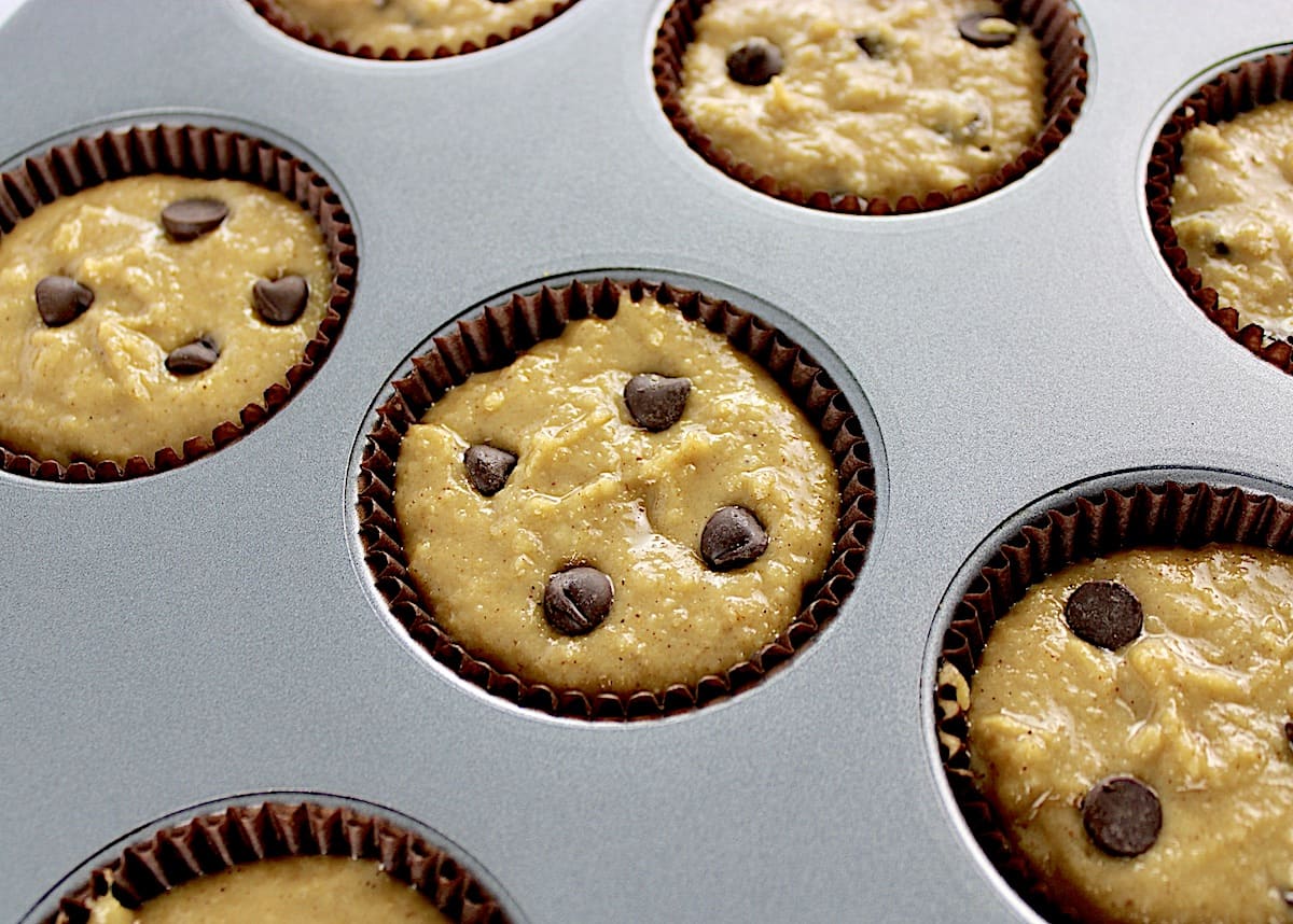closeup of Gluten Free Banana Chocolate Chip Muffins batter in muffin pan unbaked