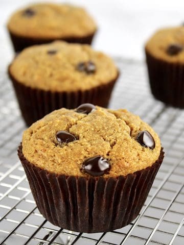 Gluten Free Banana Chocolate Chip Muffins in brown liners on cooling rack