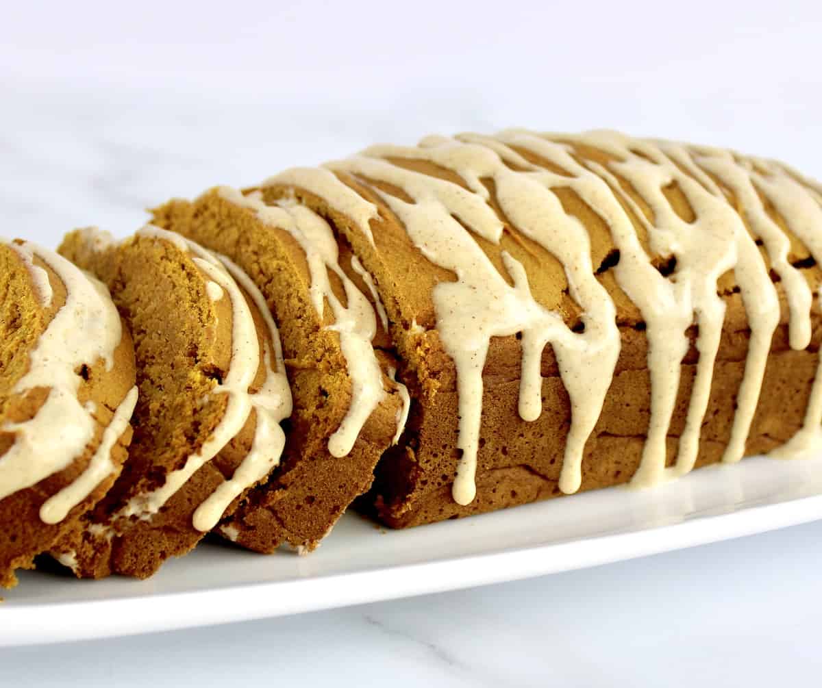 side view of Gluten Free Pumpkin Bread with icing dripping on the sides