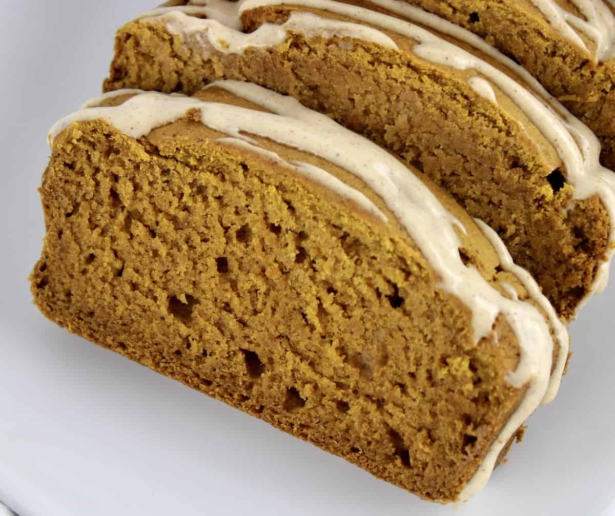 closeup of slices of Gluten Free Pumpkin Bread with icing on top