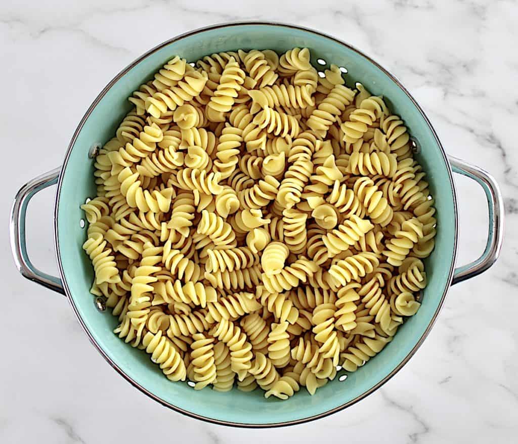 rotini pasta in blue colander 