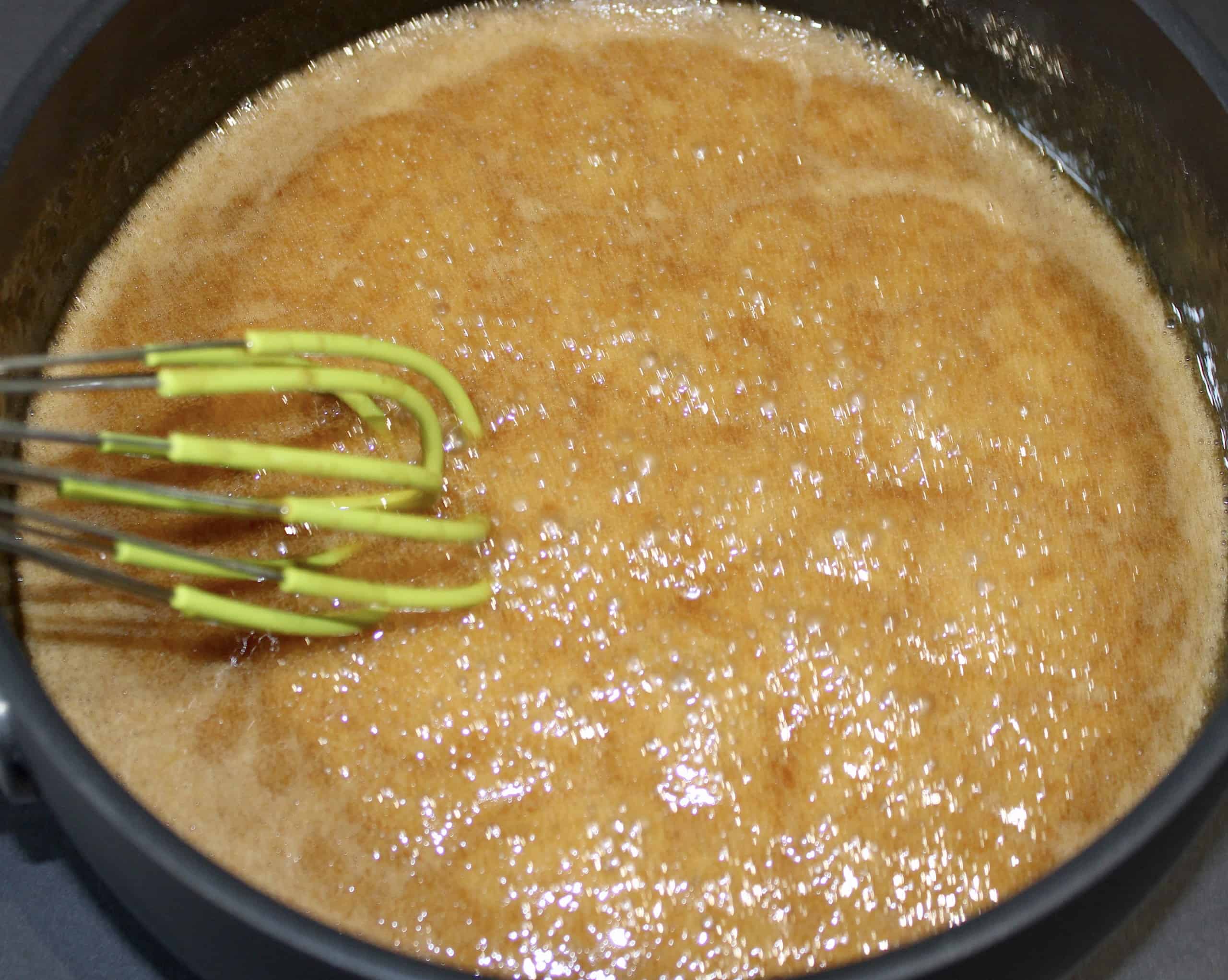 caramel sauce in pan with whisk