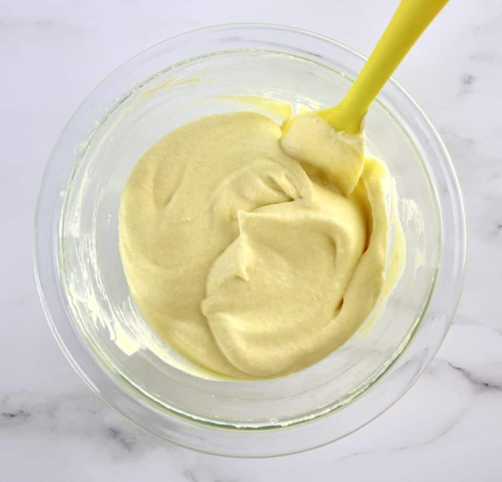 Mango Mousse in glass bowl with yellow spatula