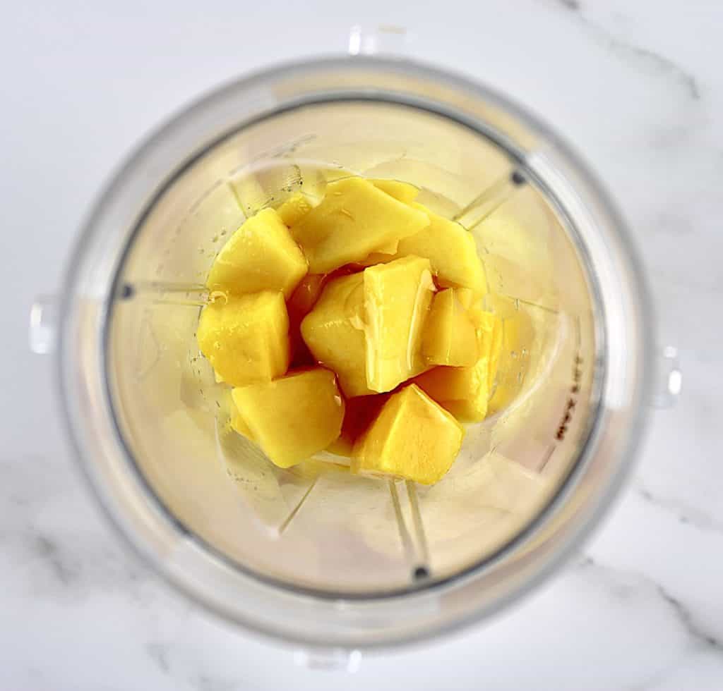 Mango chunks in cup of bullet blender