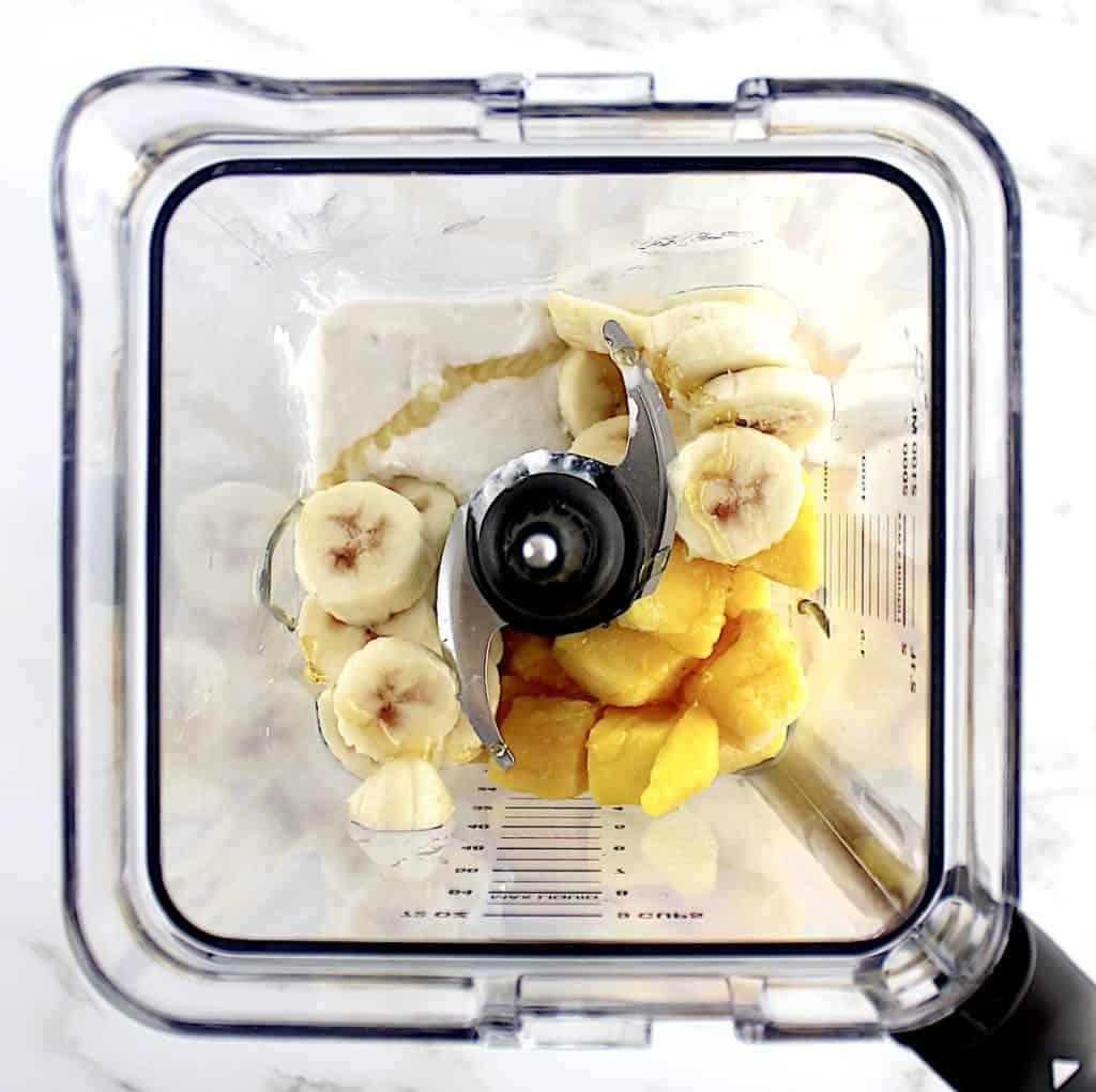 frozen mango sliced frozen banana coconut cream and honey in blender unmixed