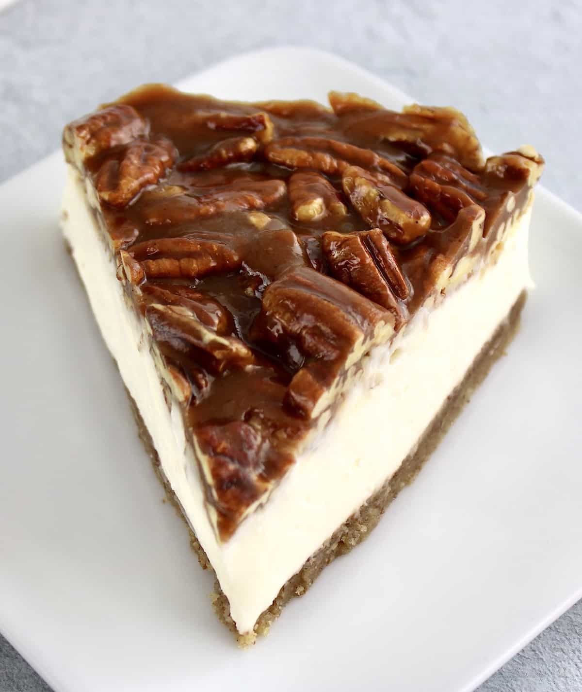 slice of pecan pie cheesecake on white plate