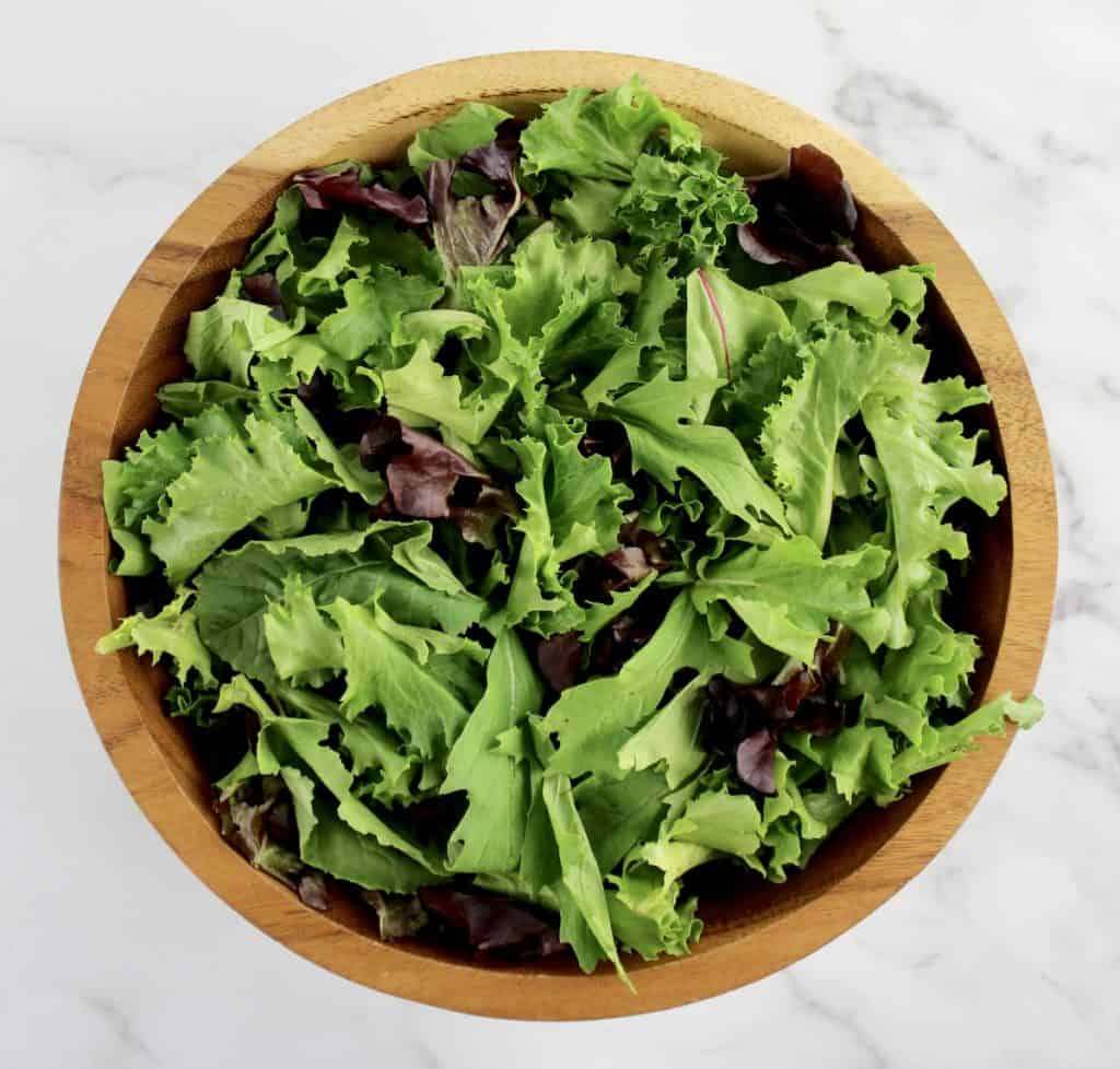 wooden salad bowl with spring mixed greens