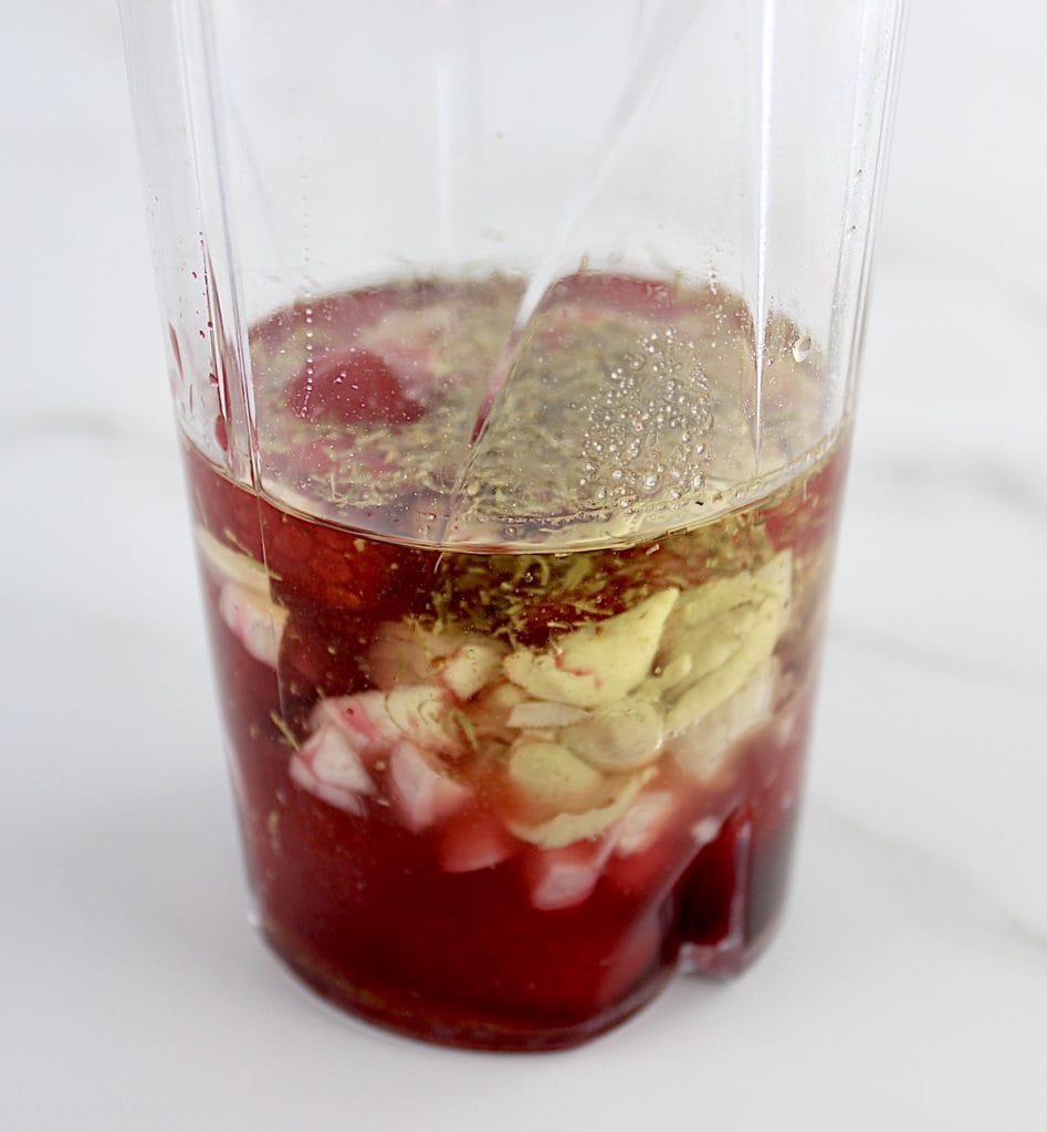 raspberry vinaigrette ingredients in bullet blender cup unmixed