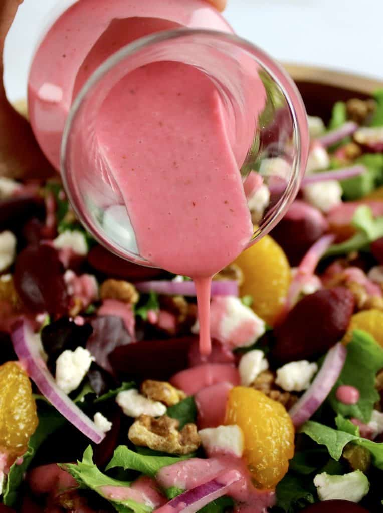 raspberry vinaigrette being poured over Pickled Beet Salad