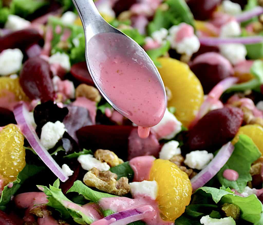 Pickled Beet Salad with raspberry vinaigrette being spooned over top