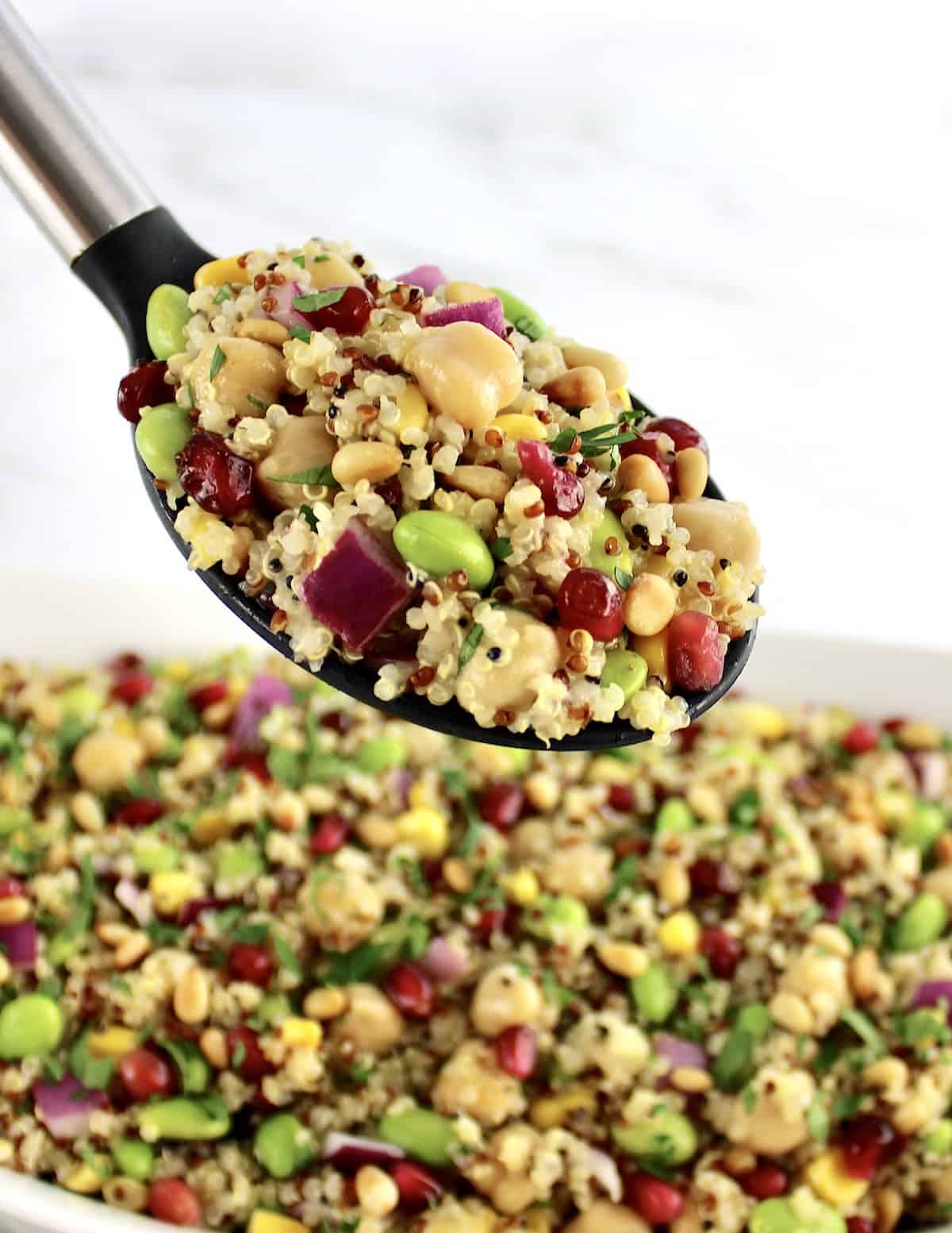 spoonful of Quinoa Salad held up over bowl