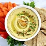 overhead view of Roasted Garlic Hummus with pita, carrots and red pepper on side