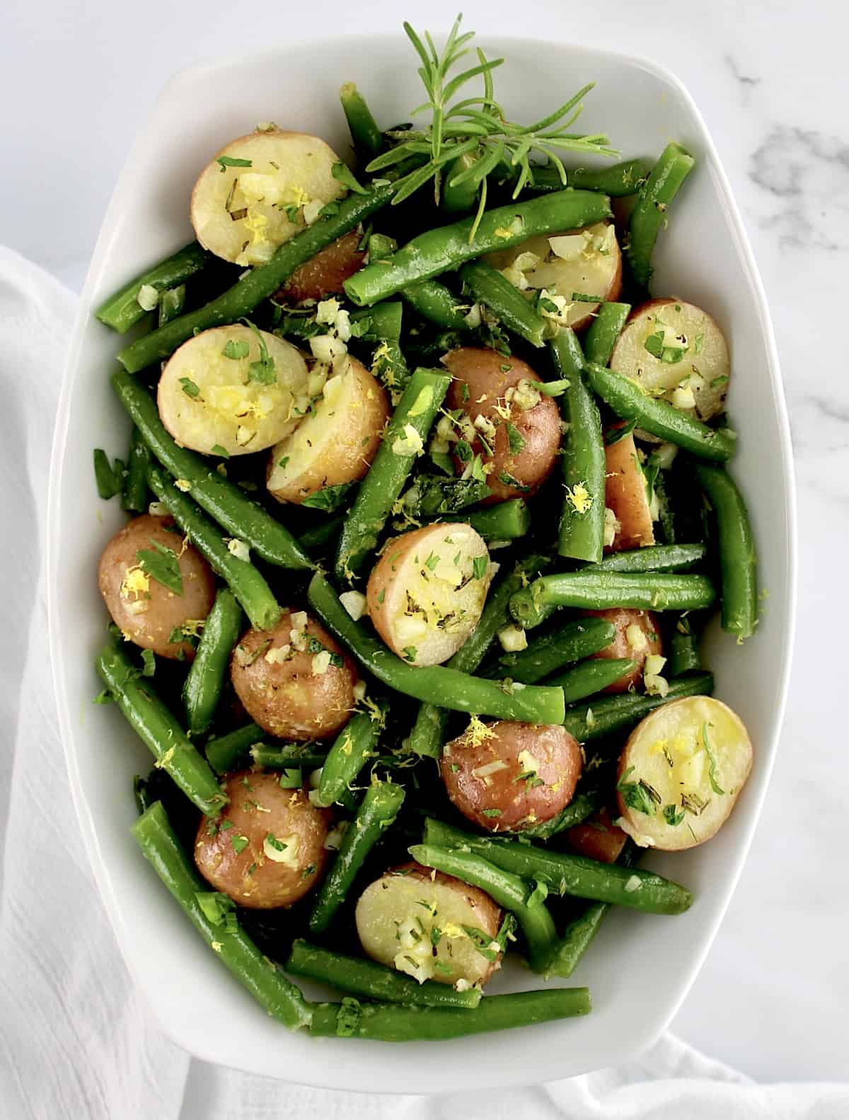 overhead view of Garlic Potatoes and Green Beans in white oval bowl