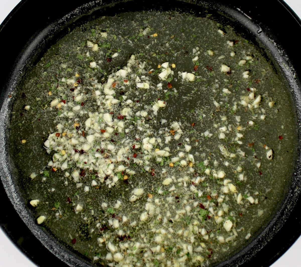 butter garlic and herbs in skillet