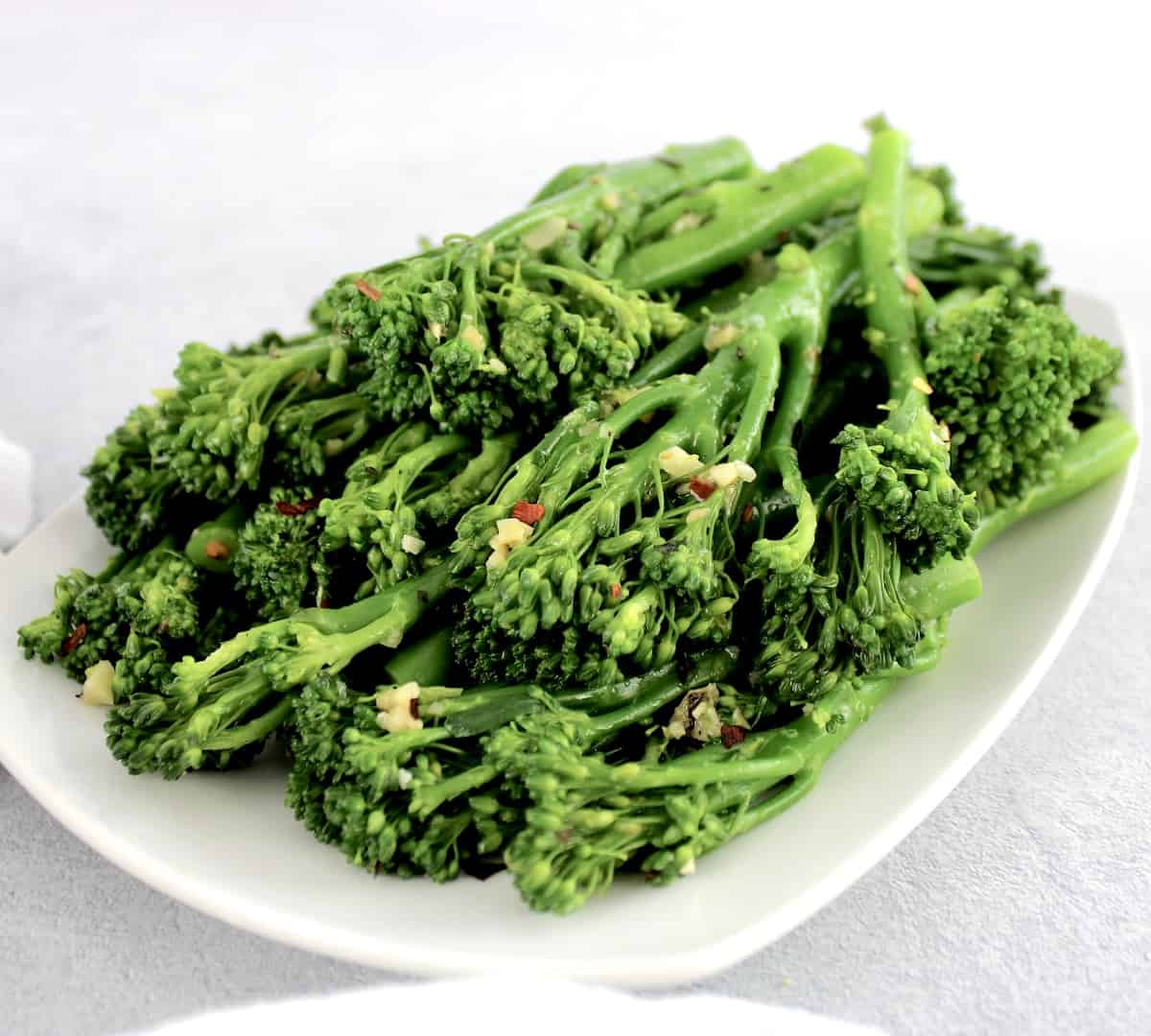 Sautéed Broccolini with Garlic on white plate