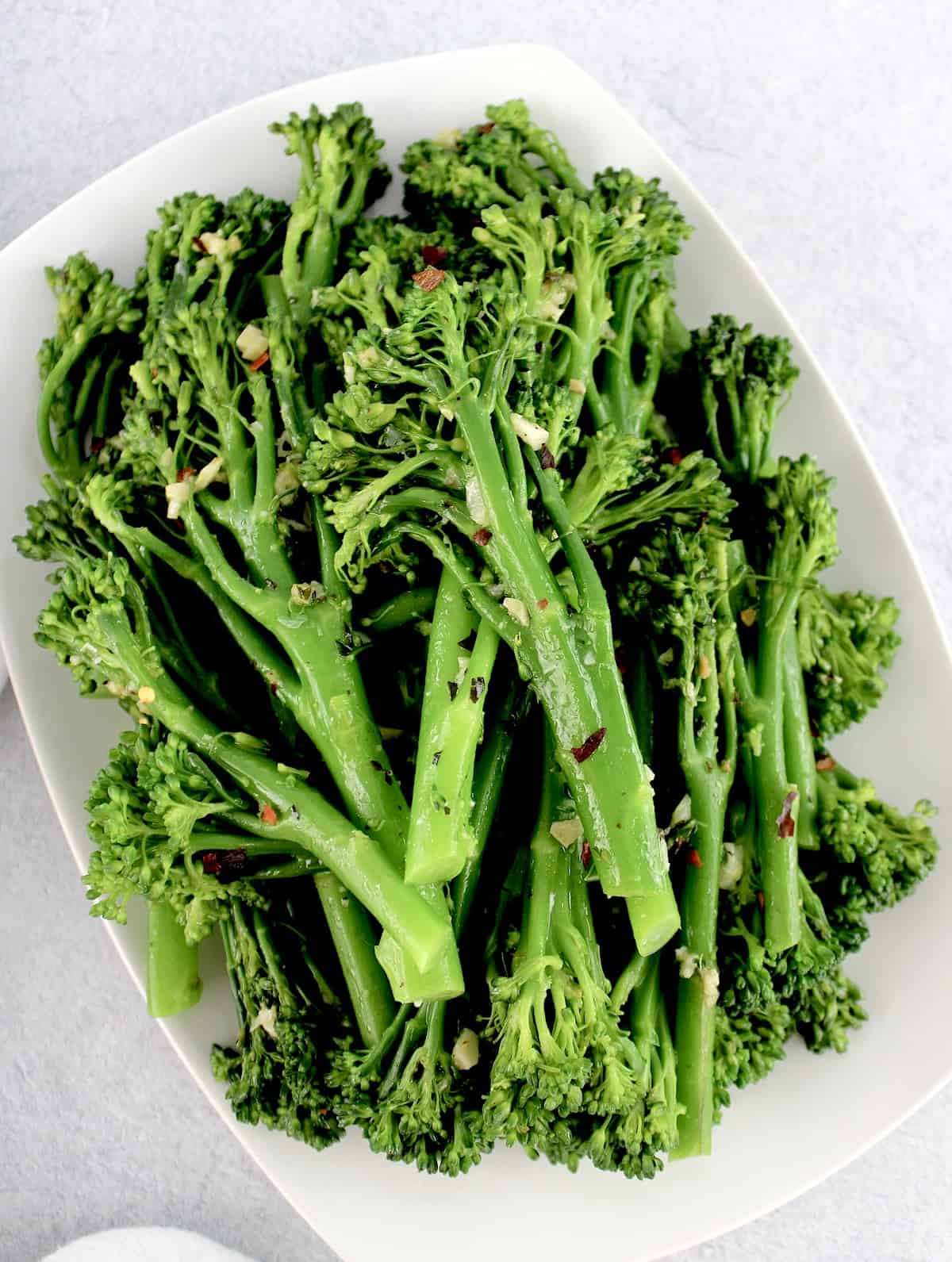overhead view of Sautéed Broccolini with Garlic on white plate