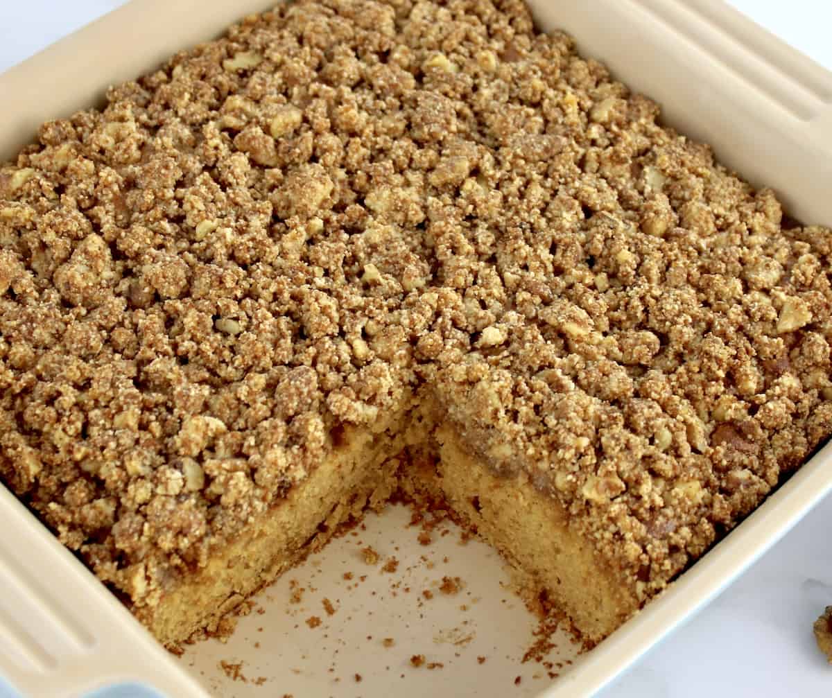 Gluten-Free Apple Cake in baking dish with slice missing