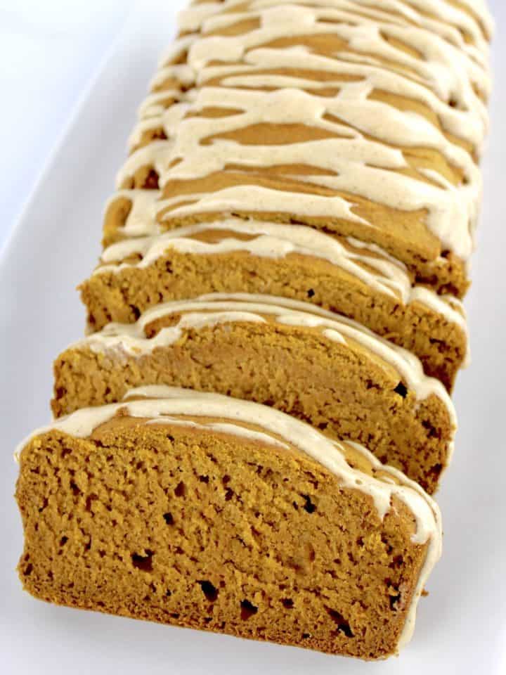 Gluten Free Pumpkin Bread with maple icing on top and a few slices cut