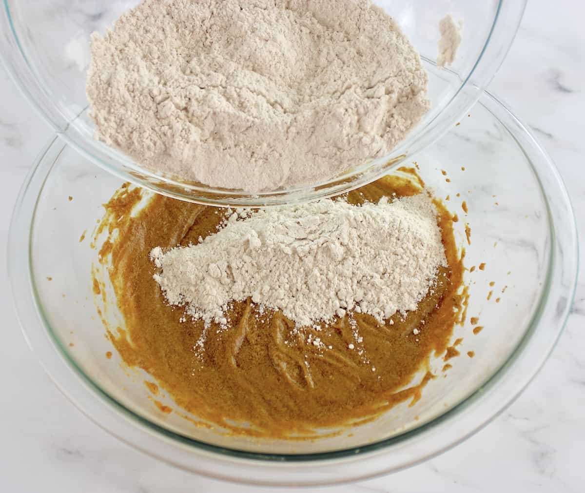dry ingredients being poured into wet ingredients for Gluten Free Pumpkin Cookies