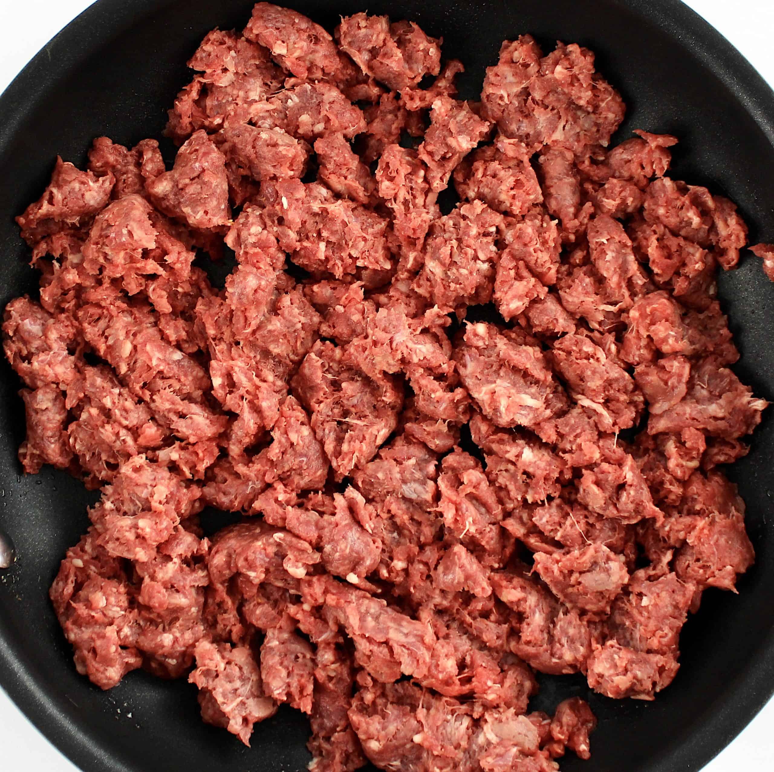 raw ground beef in skillet