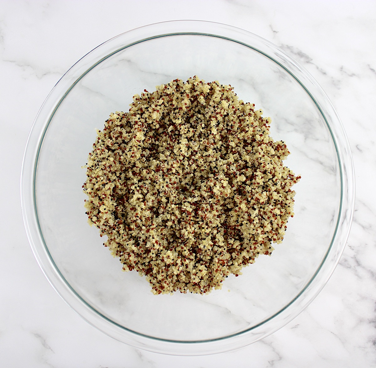 overhead view of cooked quinoa in glass bowl