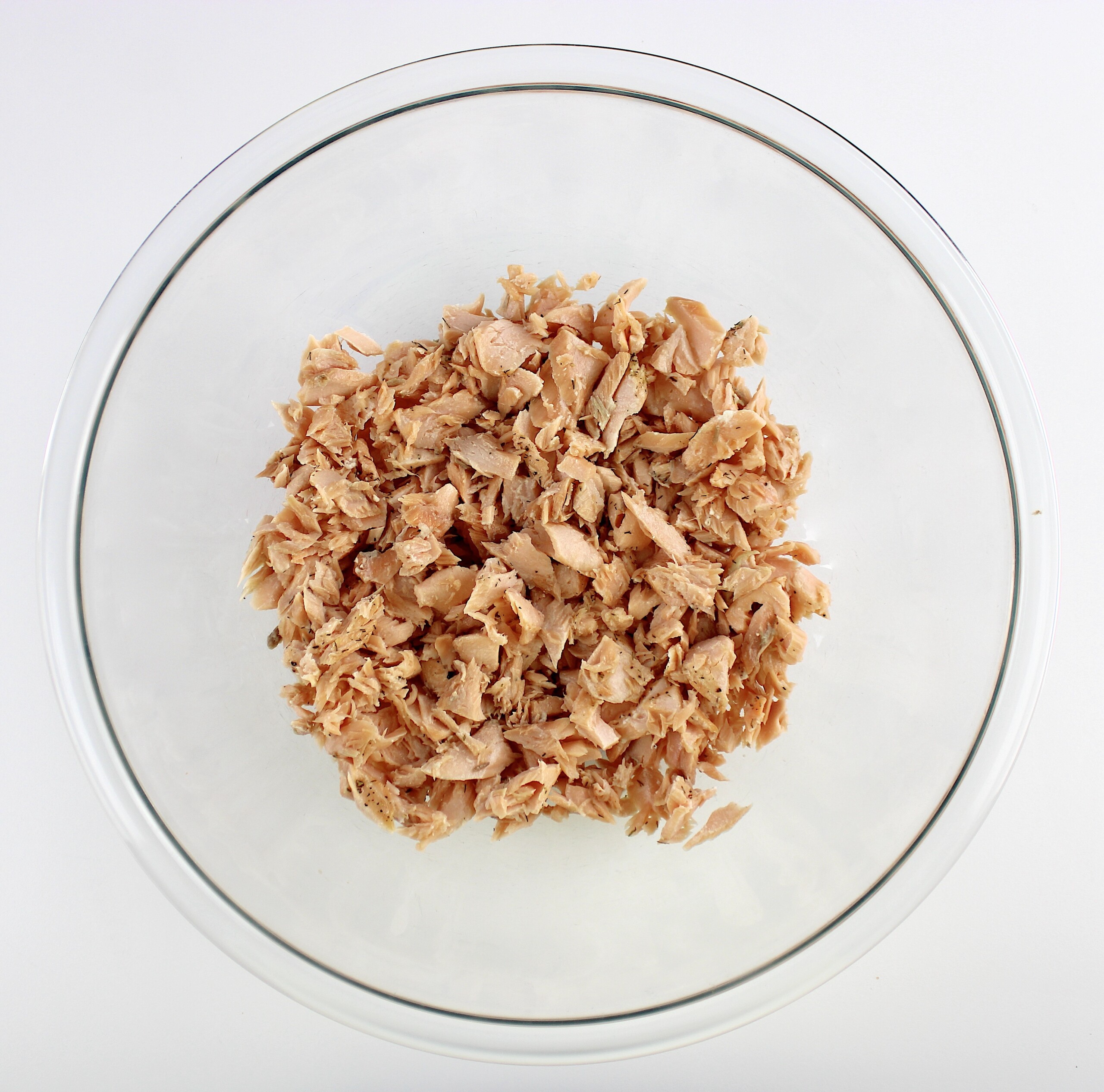 flaked cooked salmon in mixing bowl