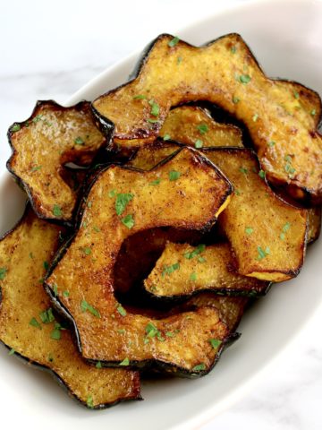 Air Fryer Acorn Squash slices on white plate