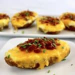 closeup of Air Fryer Twice Baked Potato on white plate with more in background