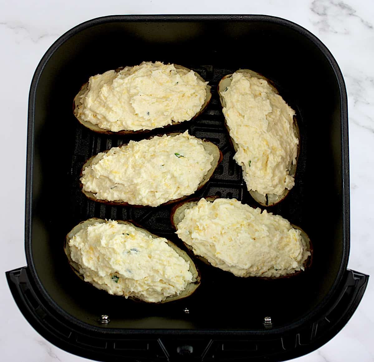 5 Air Fryer Twice Baked Potatoes in air fryer basket