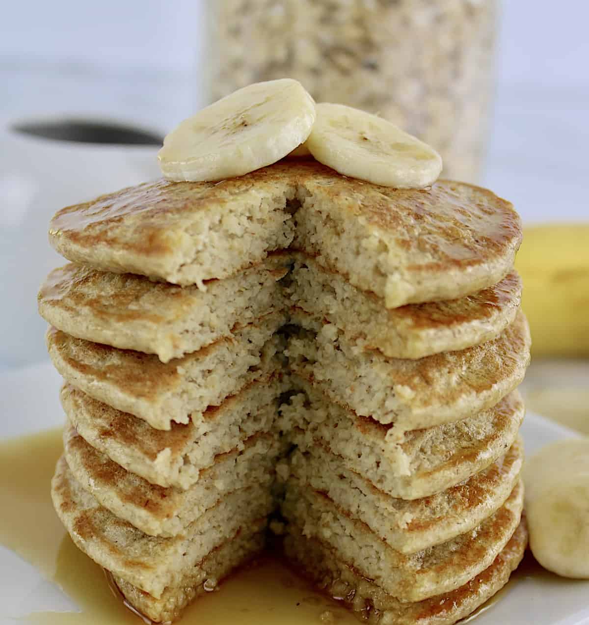 Banana Oat Flour Pancakes stack with slice taken out