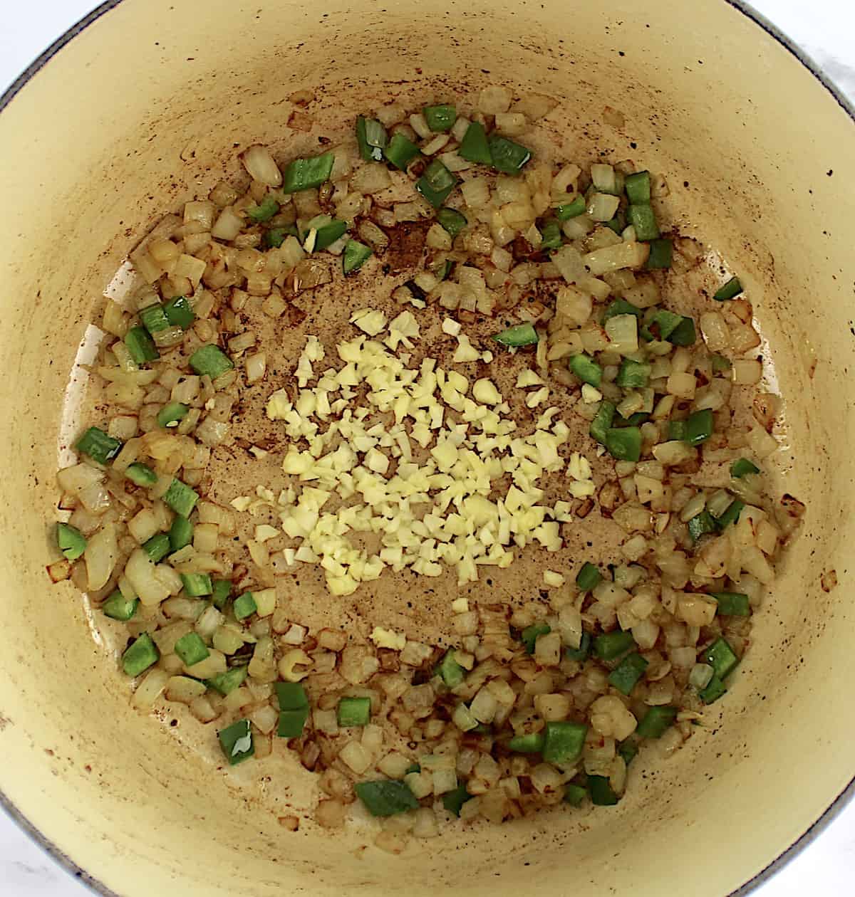 diced onions, jalapeno and garlic cooking in pot