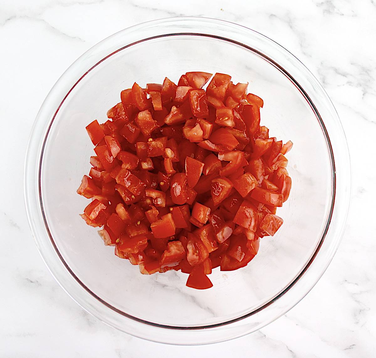 diced tomatoes in glass bowl