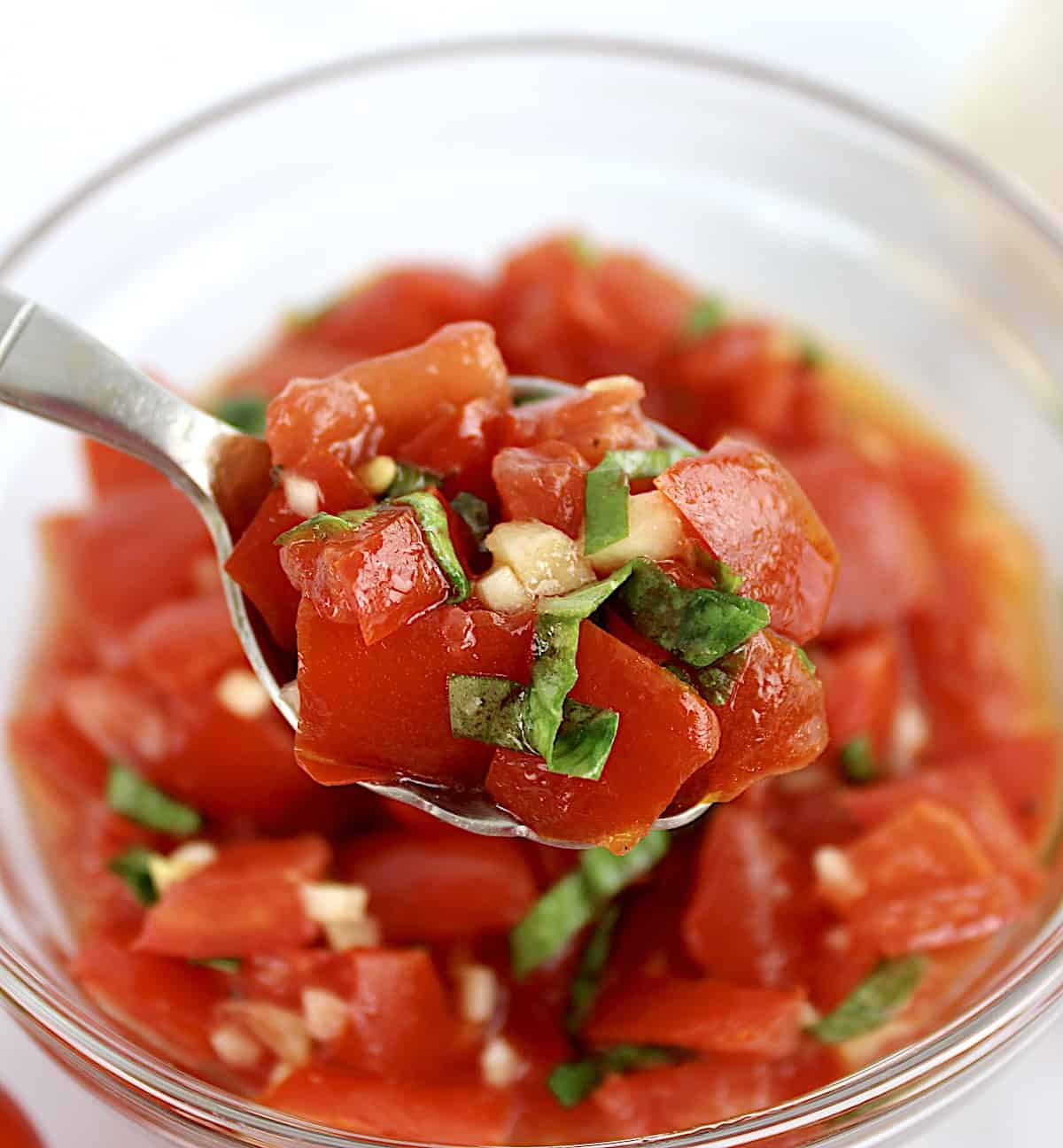 tomato Bruschetta being spooned out of bowl