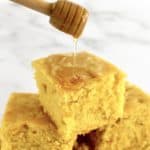 Gluten Free Cornbread slice with honey being drizzled over top