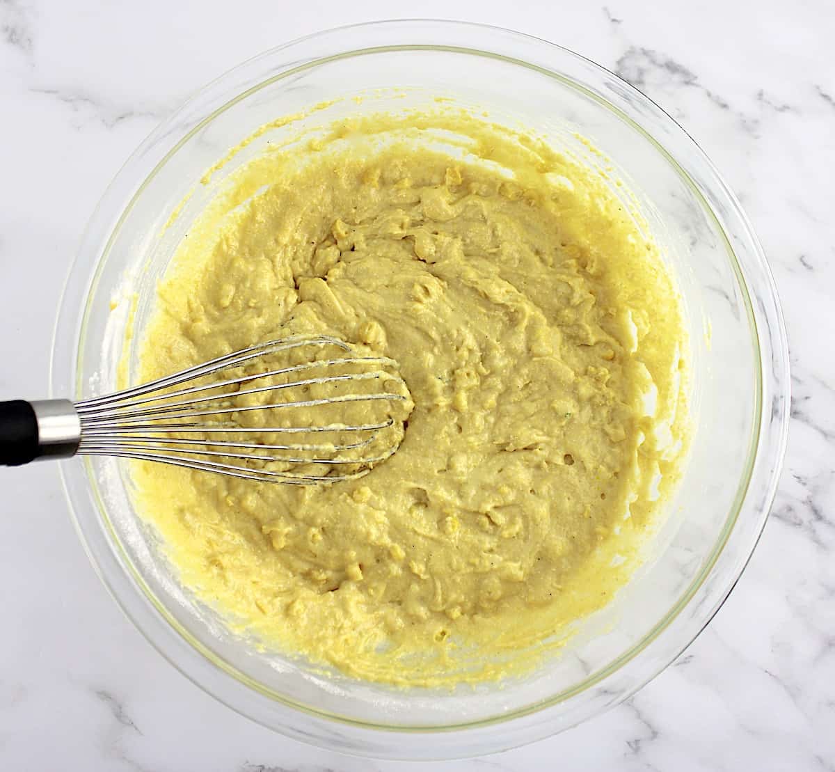 Gluten Free Cornbread batter in glass bowl with whisk