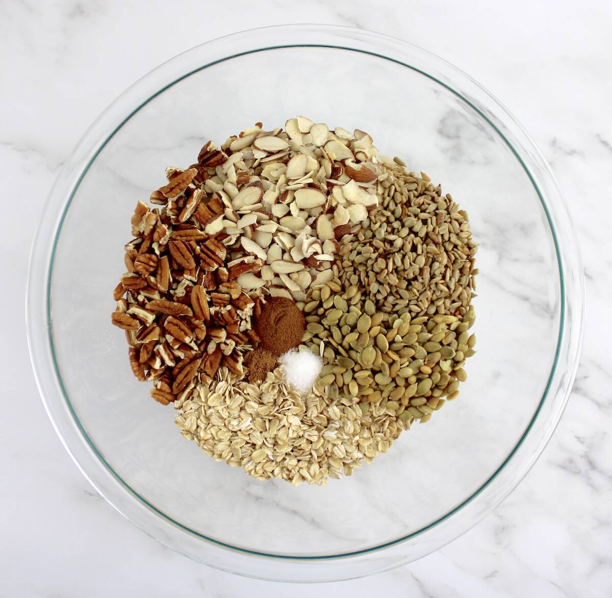 oats nuts and seeds in glass bowl unmixed