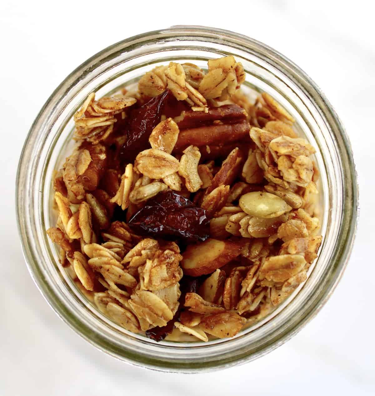 overhead view of Homemade Granola in open glass jar