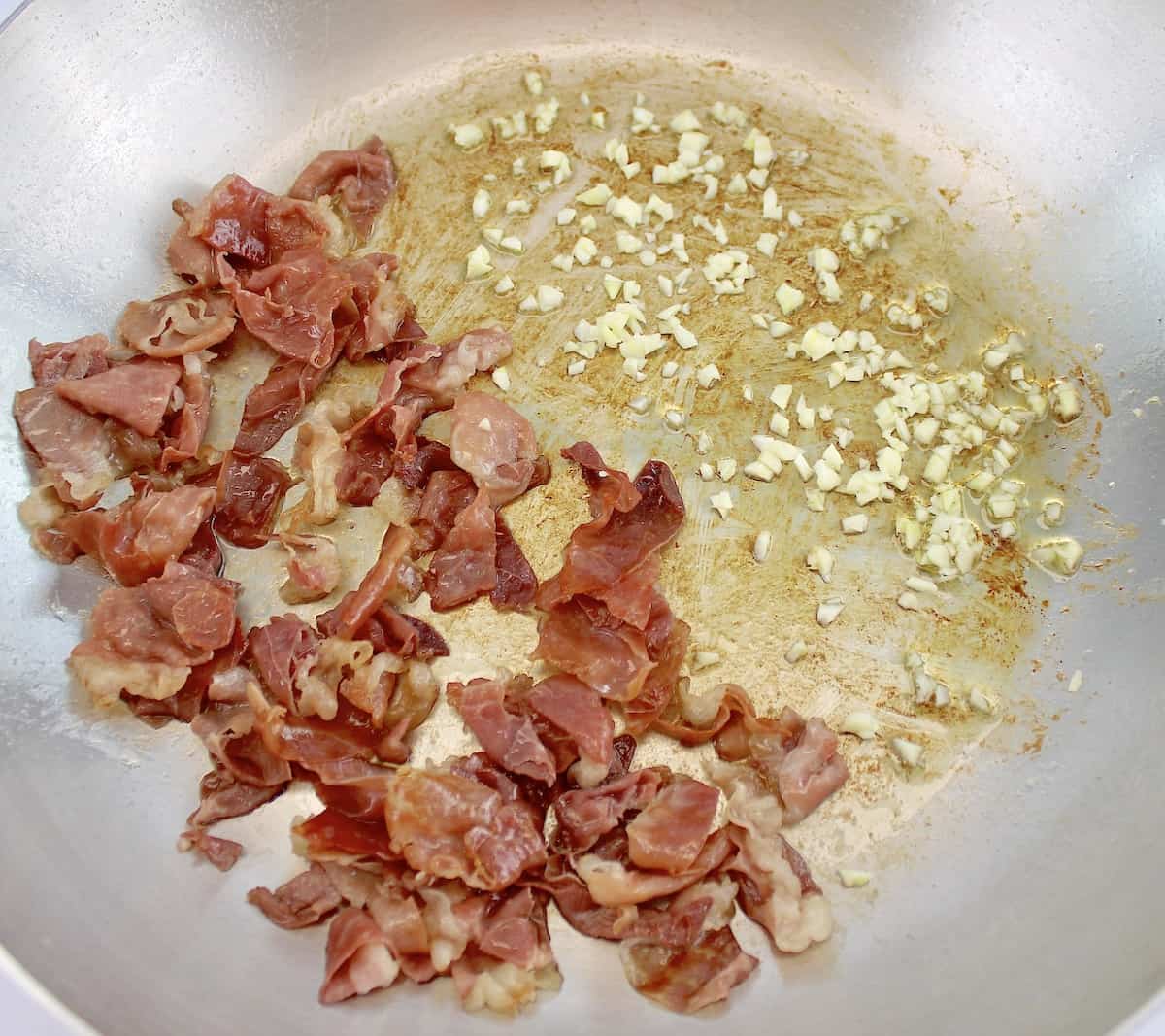 prosciutto being sauteed in skillet