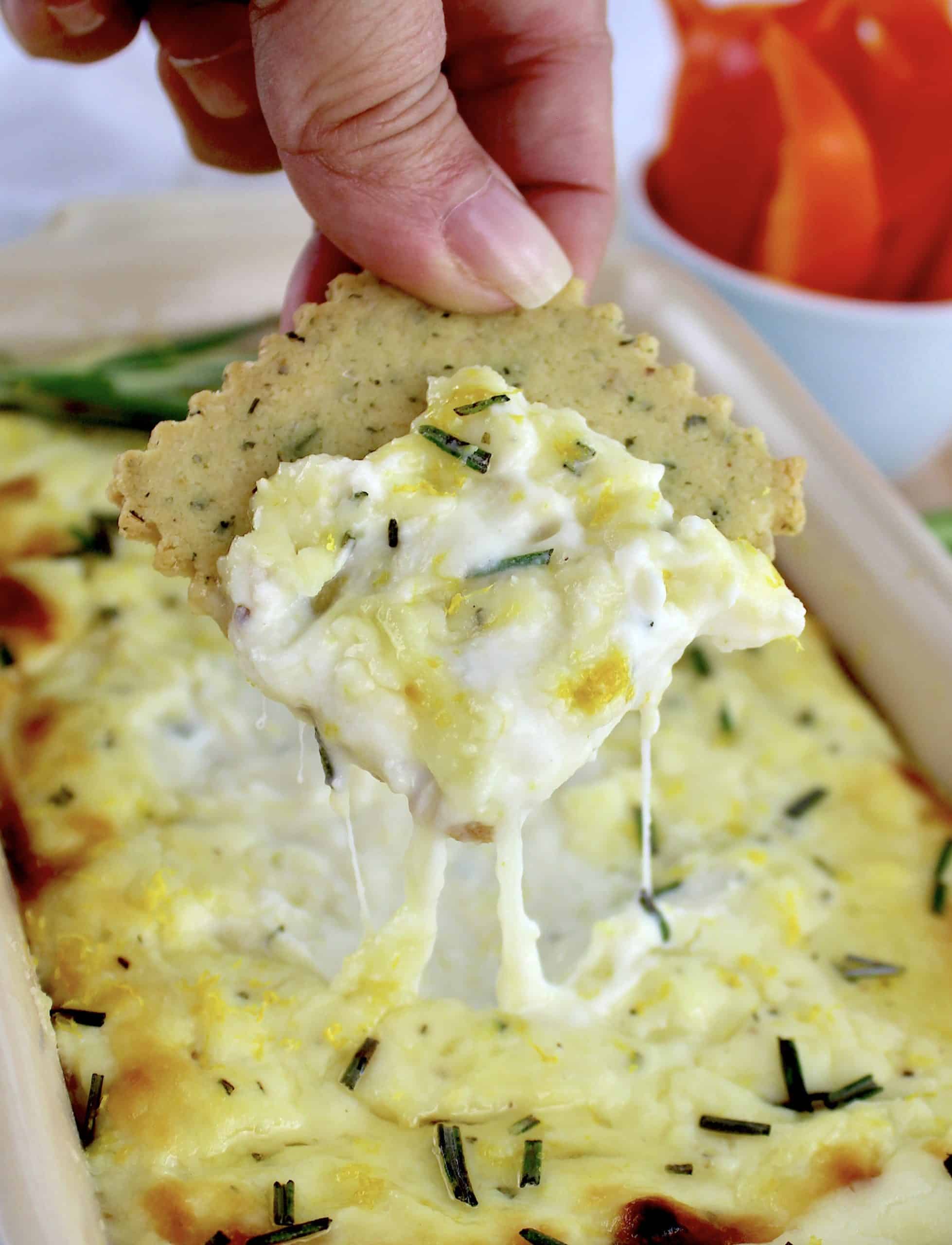 Ricotta Dip with cracker being dipped in
