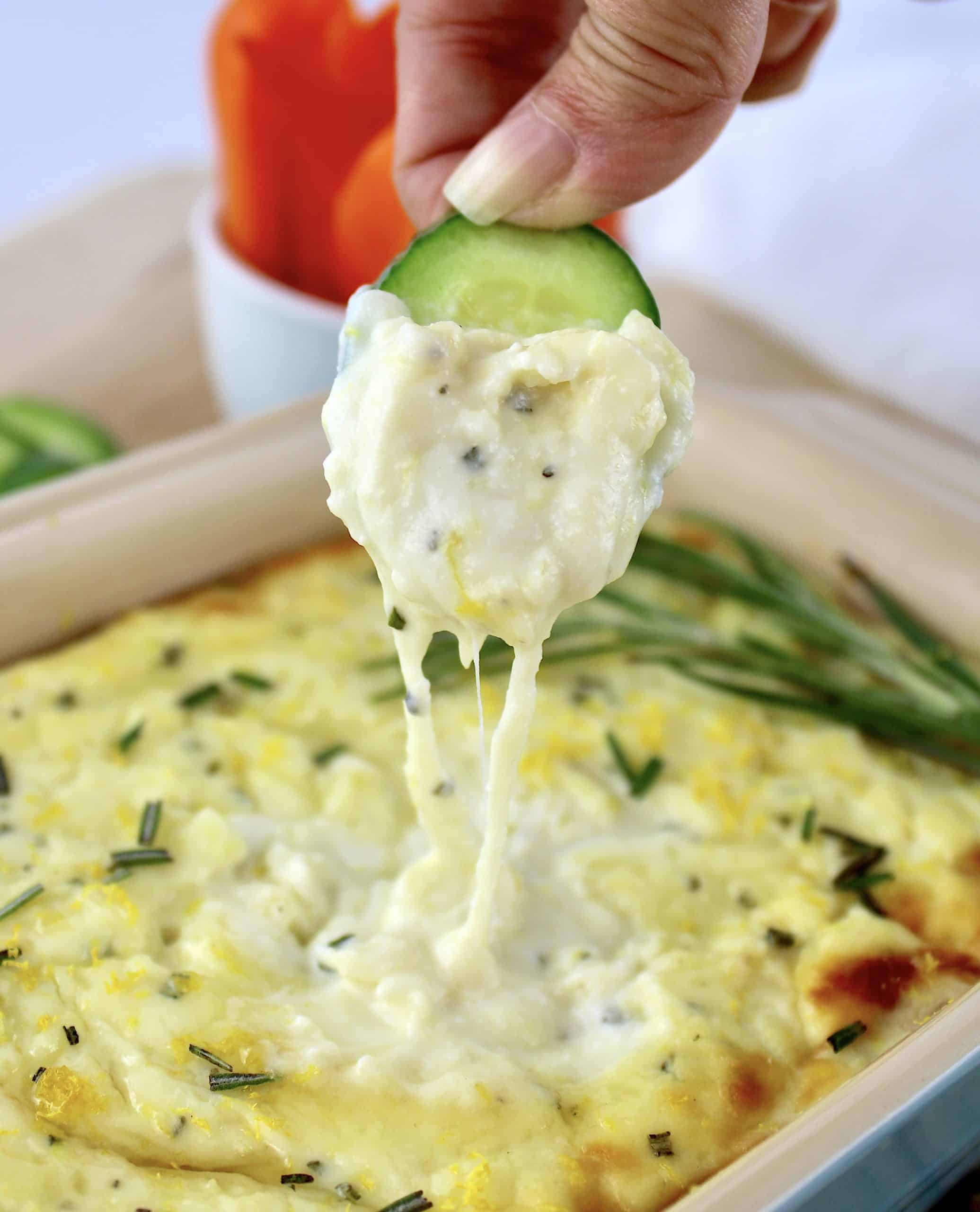 cucumber slice being dipped in Ricotta Dip