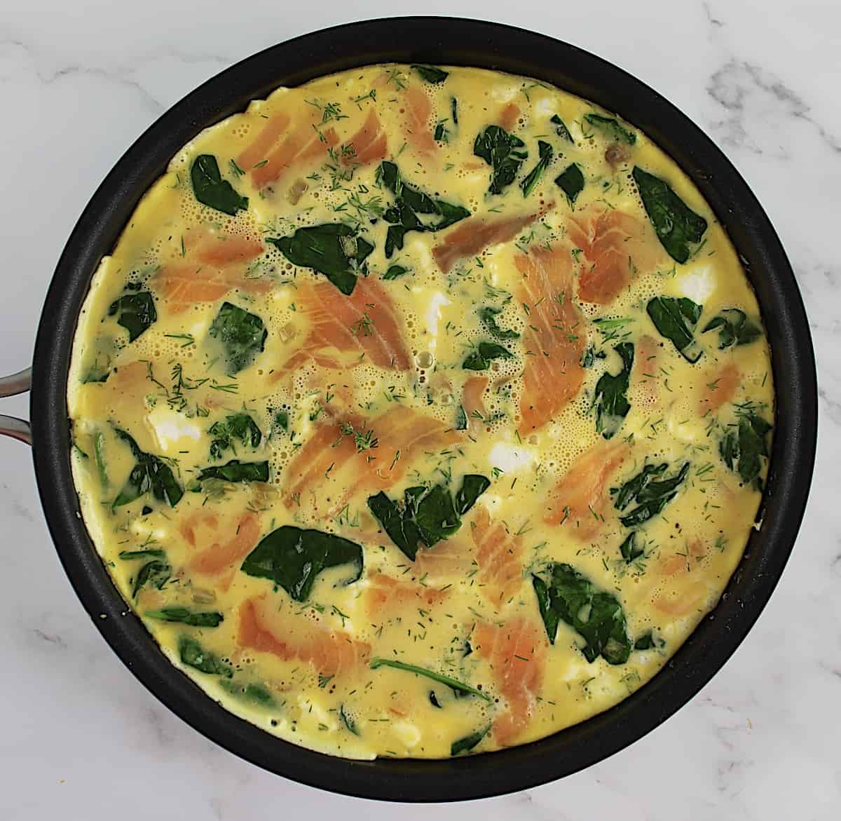 half cooked Smoked Salmon Frittata in skillet