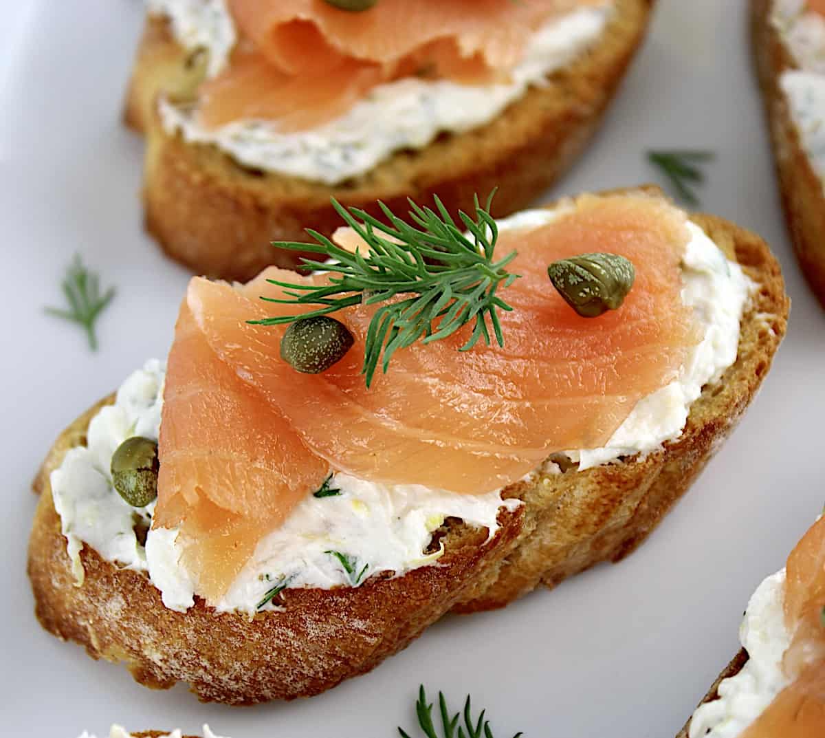 Smoked Salmon and Goat Cheese Crostini on white plate