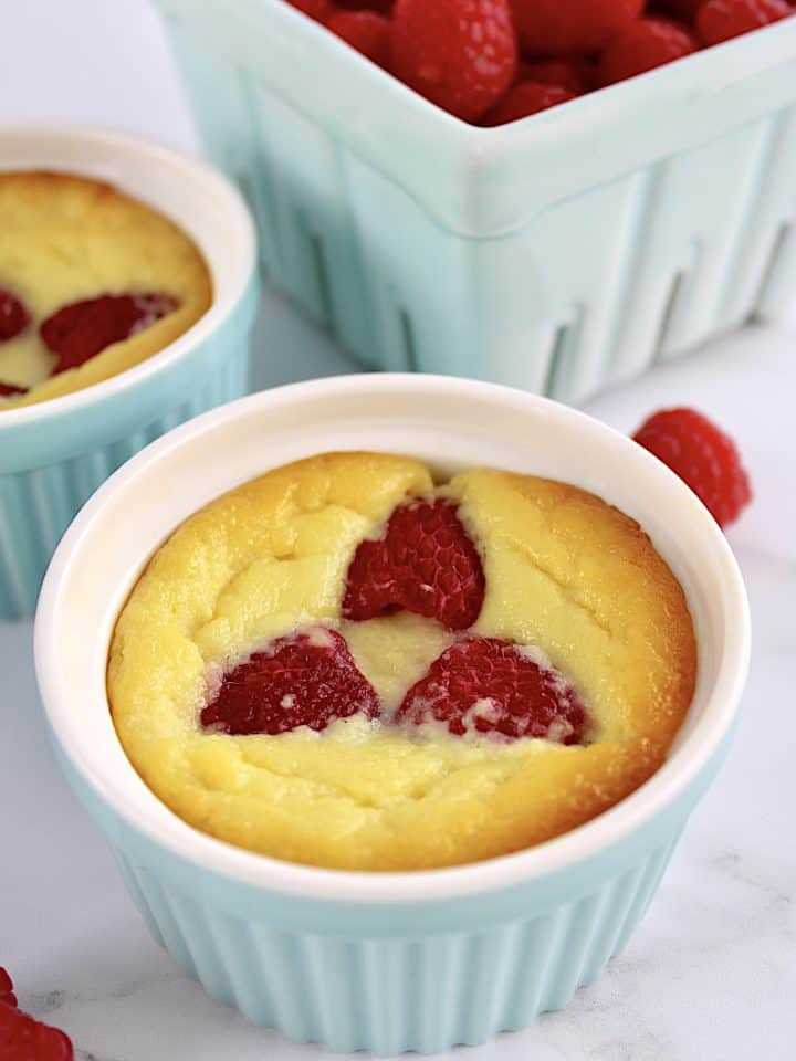 Baked Ricotta Raspberry Pudding in blue ramekin