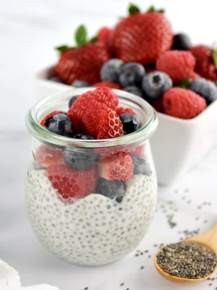 Chia Seed Pudding in glass jar with chopped berries on top