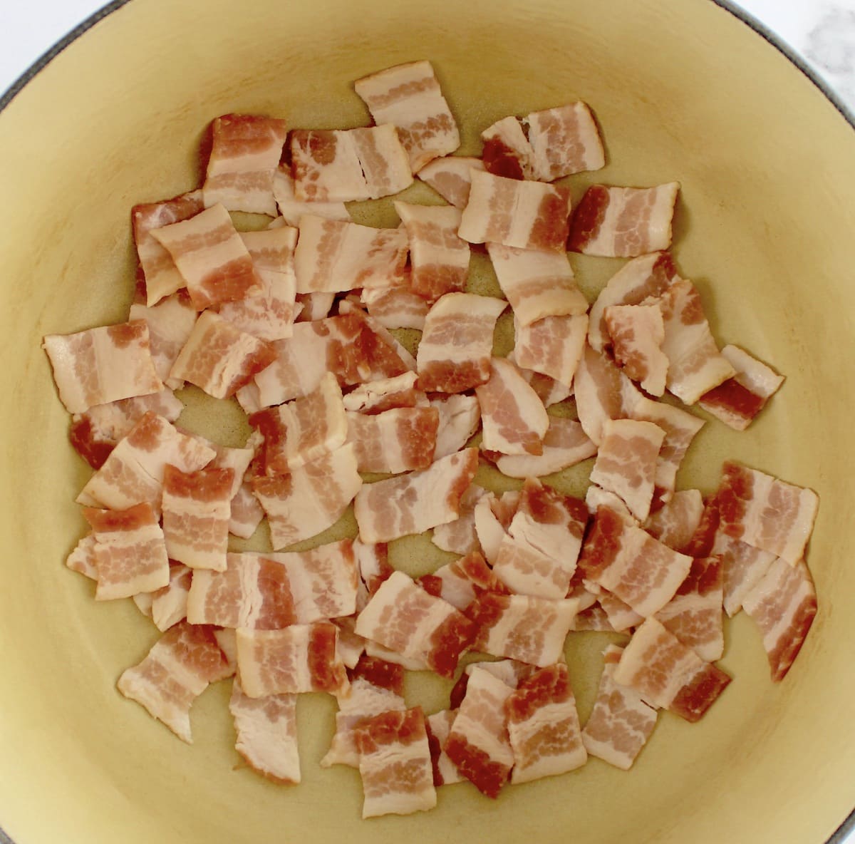 chopped raw bacon in dutch oven