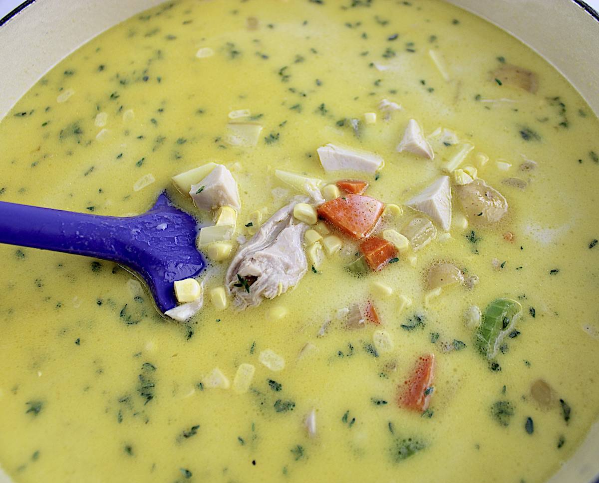 Chicken Corn Chowder in pot with purple spoon uncooked