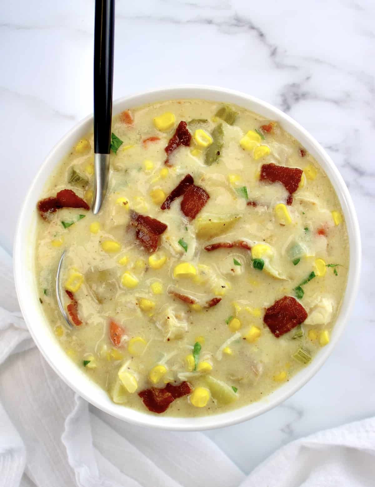 Chicken Corn Chowder in white bowl with spoon